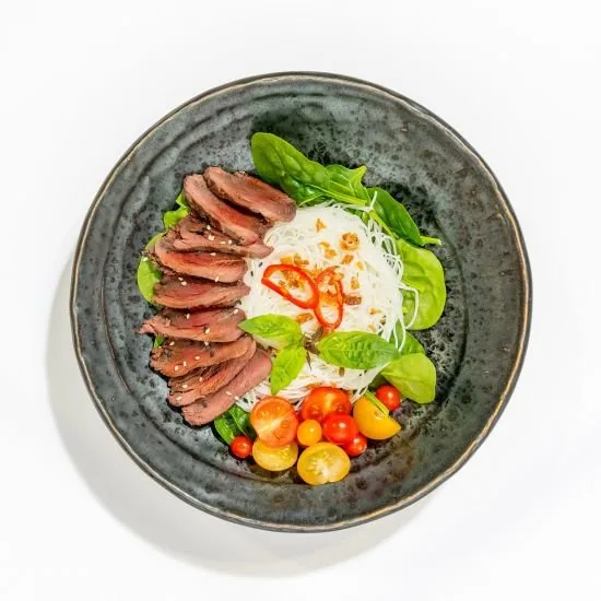 Native Inspired dish: seared kangaroo with rice noodles and native greens