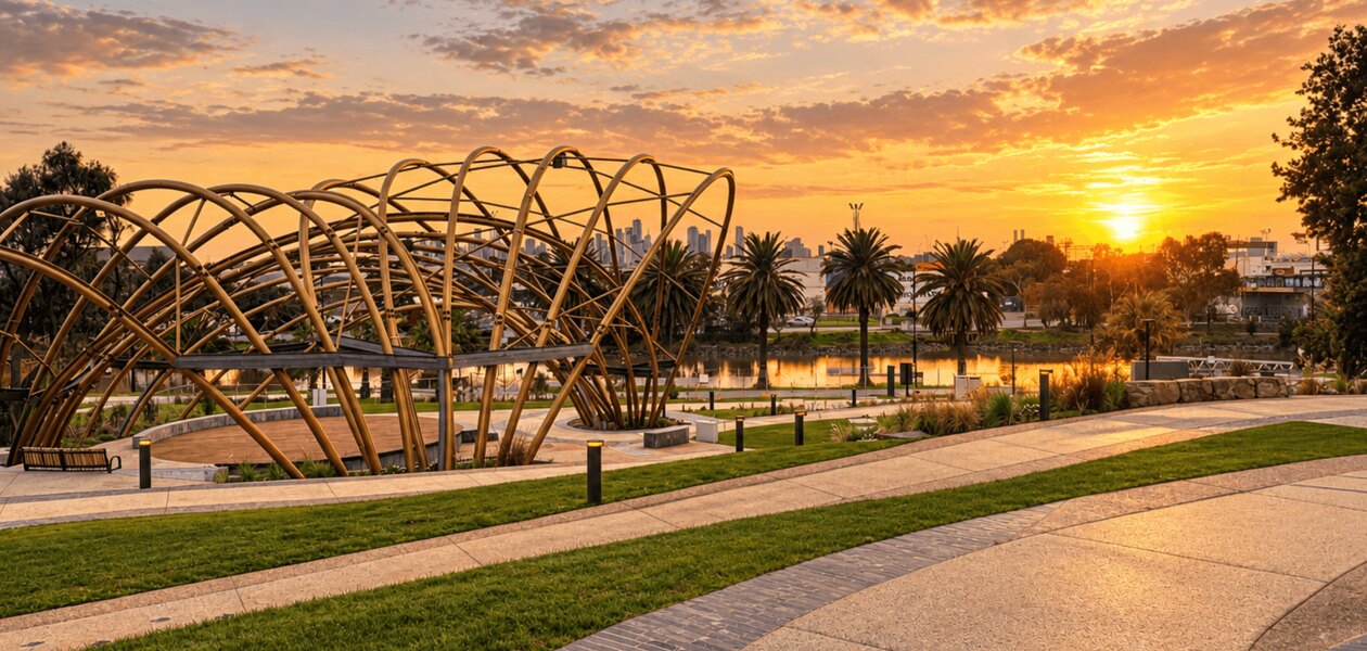 The riverside pavilion at Footscray Community Arts at sunset, Maribyrnong River and the Melbourne skyline beyond